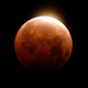A total lunar eclipse is seen over Santa Monica Beach in Santa Monica, Calif., Wednesday, May 26, 2021. The first total lunar eclipse in more than two years is coinciding with a supermoon for quite a cosmic show.